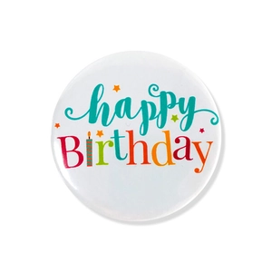 Close-up of Happy Birthday tinplate badge with colorful rainbow lettering on white background