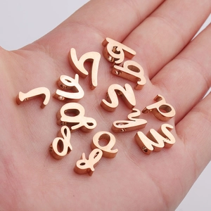 Rose gold stainless steel alphabet beads A-Z with 1.8mm hole displayed on a palm