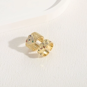 Detail of 14K gold plated wide rings with heart cutout, mesh and hammered zircon textures