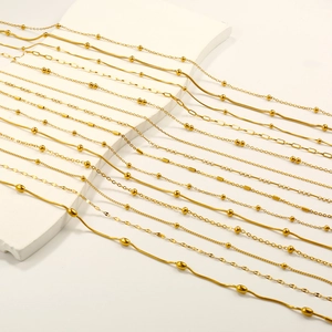 Detail of 18k gold plated stainless steel snake, bead and link chains set for women