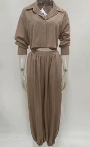 Detailed view of women's brown two-piece set with cropped shirt and elastic jogger pants