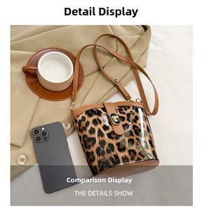 Detail shot of leopard print bucket bag with gold buckle and brown leather strap