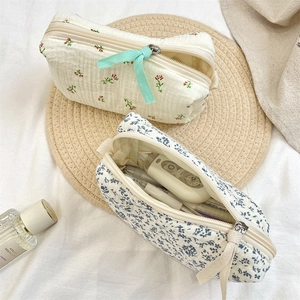 Close-up of floral makeup bags with waffle texture fabric and ribbon zipper pulls