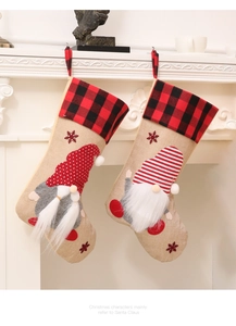 Close-up of rustic Christmas stockings with gnome embroidery hanging on white fireplace