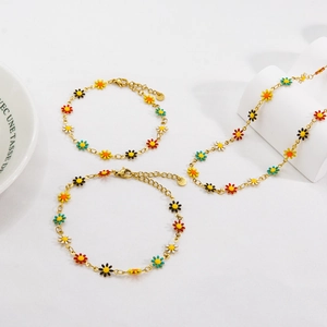 Chic gold titanium daisy jewelry set featuring colorful enamel flower necklaces and bracelets