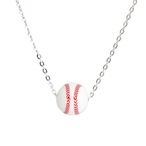 Macro detail of baseball pendant necklace with realistic red stitching on white finish
