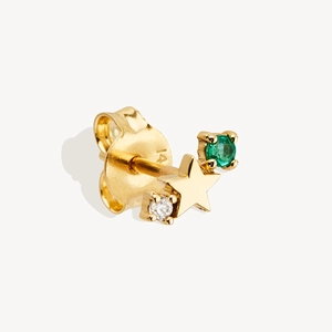 Macro shot of 14K gold-plated star stud earrings with green emerald and white diamond