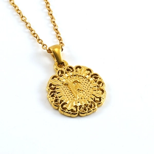 Detail showing an 18k gold plated round letter F pendant with an elegant floral border