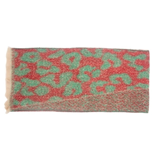 Detailed macro view of high-quality red scarf with green leopard pattern and beige fringes