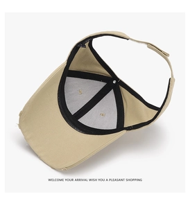 Detail of adjustable velcro strap and frayed brim on khaki outdoor ponytail cap
