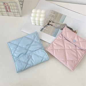 Quilted satin sanitary storage bags in pink and blue with heart button details
