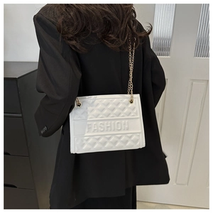 Detail of white quilted crossbody bag with golden chain and Fashion embossed letters