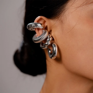 Close-up of silver-tone ear cuff set with twisted and textured spiral designs