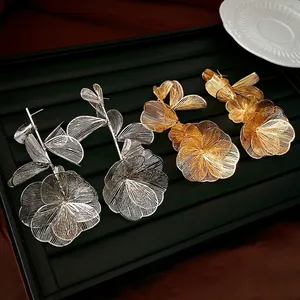 Oversized hollow flower fringe earrings in gold and silver metal mesh design
