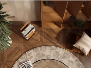 Detail of round floral living room carpet on wood floor with warm home decor lighting