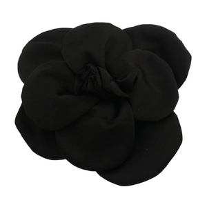 Detailed view of layered black fabric rose brooch with intricate petal textures and design