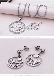 Macro detail of stainless steel bird necklace and earrings set with crystal pavé circle