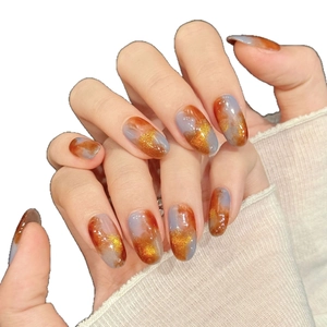 Almond press-on nails with amber and blue marble pattern featuring gold glitter accents