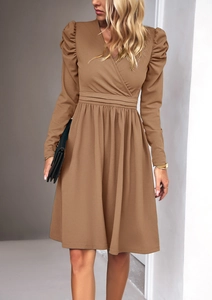 Detail view of the V-neckline and puff sleeve design on this elegant brown midi dress