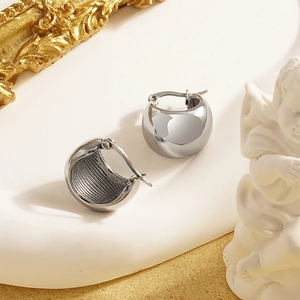 Polished silver chunky hoop earrings for women on a white elegant pedestal display