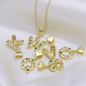 Gold balloon alphabet necklace with colorful cubic zirconia on silk background