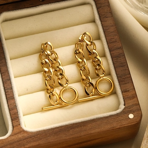 Close-up of gold-plated 18K stainless steel OT buckle chain earrings in a wooden jewelry box
