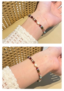 Detail of colorful gemstone and pearl beaded bracelet on a woman wrist