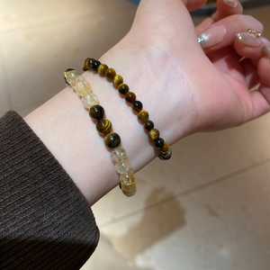Detailed shot of Tiger Eye and Rutilated Quartz beaded bracelets set for women