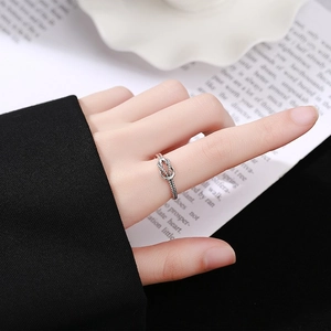 Vintage S925 sterling silver twisted knot ring with an antique finish on model hand