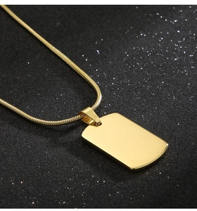 Detailed close-up of a polished gold rectangular tag pendant on a sleek snake chain