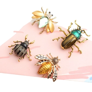 Set of four luxury bee and beetle insect brooches with rhinestones and emerald crystals
