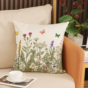 Close-up of square cushion cover with floral and butterfly print on a sofa