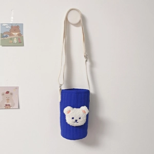 Quilted blue water bottle bag with plush bear head and adjustable beige shoulder strap