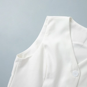 Detail of white V-neck waistcoat featuring premium diagonal twill texture and single button