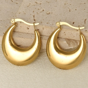 Macro view of gold plated 304 stainless steel U-shape hoop earrings on stone
