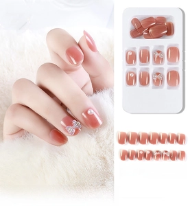 Detail view of 24pcs pink press-on nails with 3D bows and elegant pearls