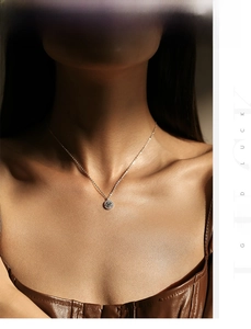 Close-up of S925 sterling silver halo pendant necklace with sparkling zircons on a model