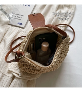 Detail view of woven straw crossbody bag interior showing phone and essentials capacity