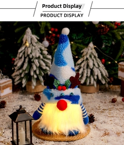Close-up of glowing Christmas gnome doll with reindeer antlers and festive pine cone decor
