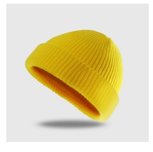Close-up of bright yellow knitted beanie hat showing elastic fine texture and texture