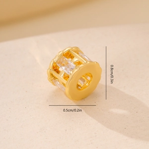 Macro view of gold metal spacer bead with rectangular zircons and size specifications
