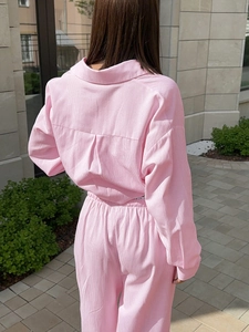Detailed back view of pink striped corduroy long-sleeve shirt and matching trousers set