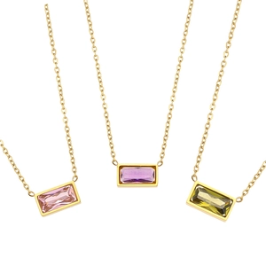 Three gold necklaces with emerald-cut crystals in pink, purple, and green colors