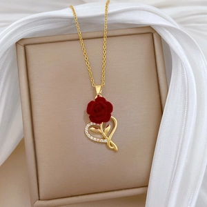 Titanium gold necklace featuring a red rose pendant and a heart-shaped diamond-encrusted frame