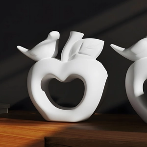 Minimalist white ceramic apple ornament with bird and hollow heart cutout for home decor