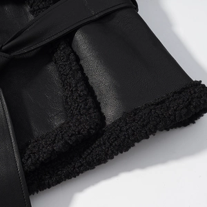 Close-up of black faux leather sleeve cuffs with thick faux shearling fur lining detail