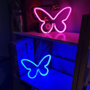 Pink and blue butterfly LED neon signs glowing on a bookshelf for room wall decoration