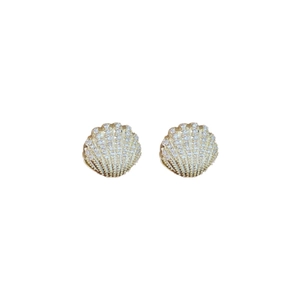 Elegant gold-plated shell earrings encrusted with zircon crystals on a white background