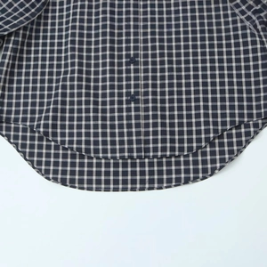 Navy blue and white plaid long sleeve shirt with curved hem and button detail