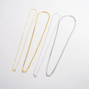 Set of gold and silver S925 flat snake bone chain necklaces in various widths on white background